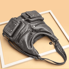 Convertible purse shoulder, or a backpack in black, gray, and tan